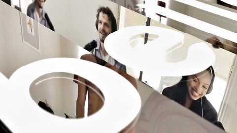 Smiling Asian woman with headphones and bearded man reflected behind shiny BOSS logo mirror