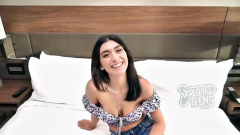 Aubrey smiling in POV on bed, cleavage in off-shoulder top, amateur teen tease