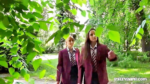Anita Bellini in school uniform walking with brunette friend in lush garden