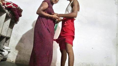 Indian housewife in purple dress holds hands intimately with partner in white top and red skirt