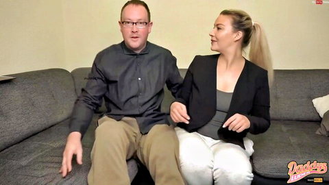 Blonde MILF in blazer chats intimately with older man on couch