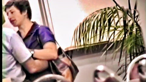 Mature Asian housewife in purple top embracing coworker in steamy scene