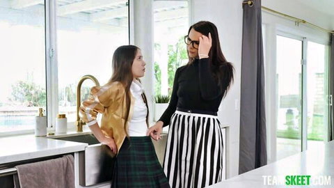 Brunette MILF stepmom in glasses chats with teen schoolgirl in plaid skirt in kitchen