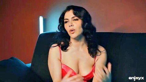 Latina beauty in red lingerie teasing with deep cleavage