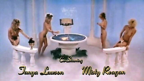 Retro nude blondes Tanya Lawson and Misty Regan posing around fountain
