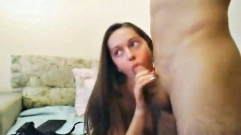 Brunette babe eagerly giving blowjob on bed