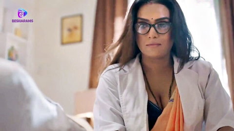 Busty Indian MILF doctor in glasses with open white coat over saree exposing black bra cleavage