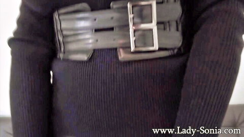 Lady Sonia in busty sweater with bondage harness, teasing nipples