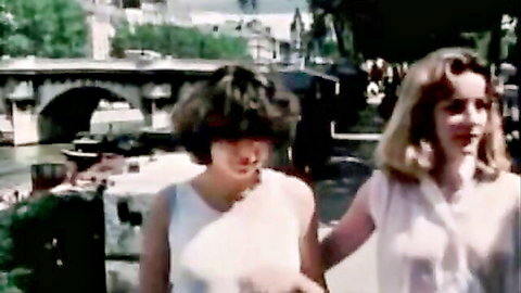 Vintage retro French brunette and blonde babes in sheer white tank tops smiling by Seine bridge