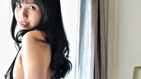 Thai model Norah Black in seductive fishnet lingerie pose, bare back and long black hair