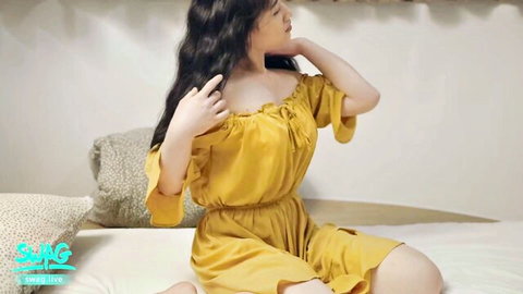 Stunning Asian babe in yellow off-shoulder dress teasing seductively
