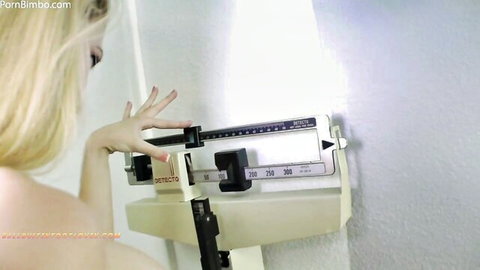 Blonde Alexan nude adjusting scale in trampling fetish preview
