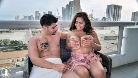 Curvy Miami MILF Tina G topless on balcony with tattooed lover