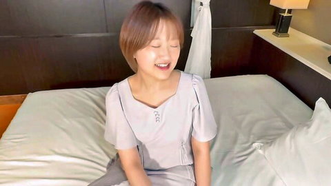 Aoi the naughty nurse in gray uniform smiling on bed, electric play tease