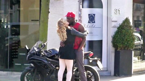 Hot blonde PAWG in short dress and stockings kisses black stud by motorcycle in interracial scene