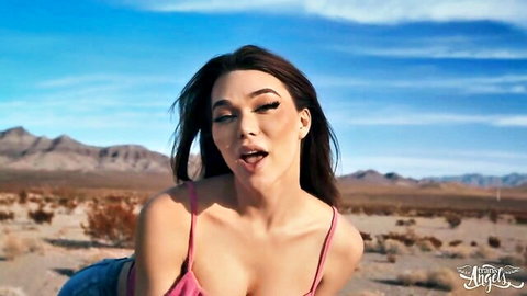 Emma Rose in pink tank top, teasing cleavage in sunny desert