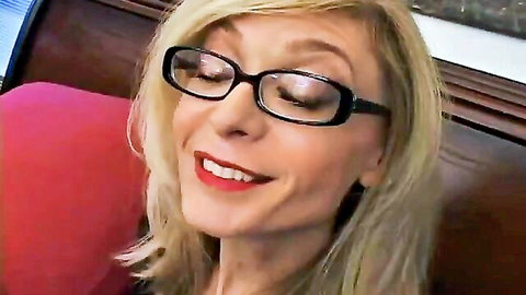 Smiling blonde cougar with glasses ready for kinky handjob and facial