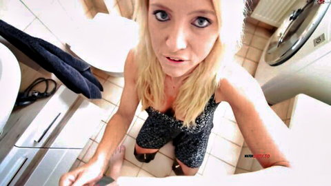 Blonde model Daynia squatting in short dress, POV bathroom tease