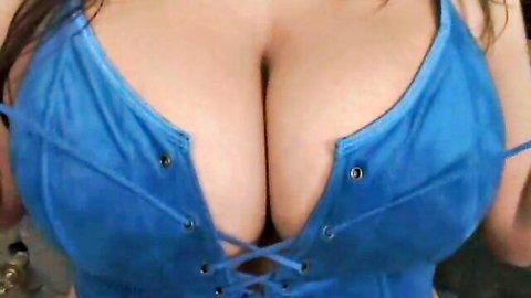 Brandy Talore's massive tits in blue lace-up lingerie, deep cleavage tease