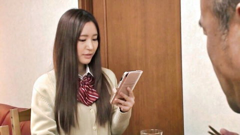 Cute Japanese schoolgirl in uniform texts on phone with father-in-law