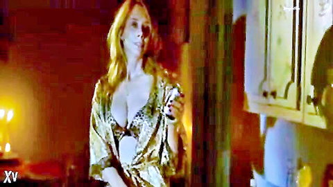 Rosanna Arquette in seductive gold robe and black lace bra, showing deep cleavage
