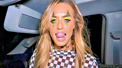 Kelsi Monroe in spooky Halloween makeup, sticking tongue out seductively in checkered top