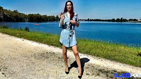 Redhead Carlie in short denim dress posing sexy outdoors by lake