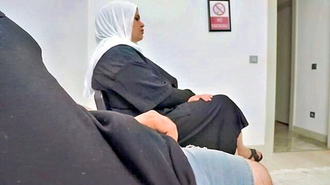 Shocked hijabi woman in abaya seduced by man in public waiting room