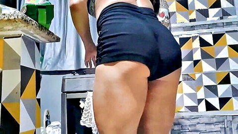 Bianca Naldy bending over in tight black shorts, thick thighs