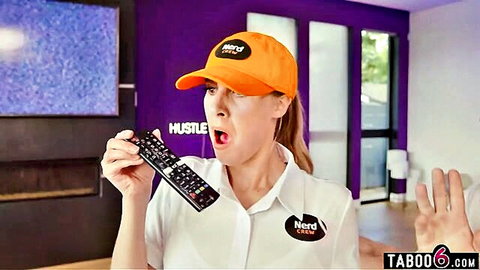 Curvy blonde in orange cap and white shirt holds remote in surprise during house call