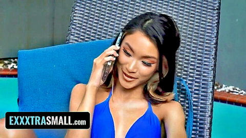 Xoey Li, tiny Asian babe in blue bikini by pool on phone call