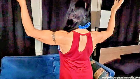 Azure Dee muscular back view in red tank top, arms raised