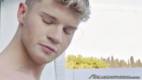 Sensual blonde gay hunk with eyes closed in ecstasy outdoors Falcon Studios