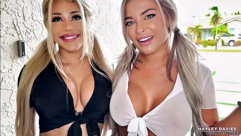 Hayley Davies and busty blonde posing in revealing crop tops, big cleavage