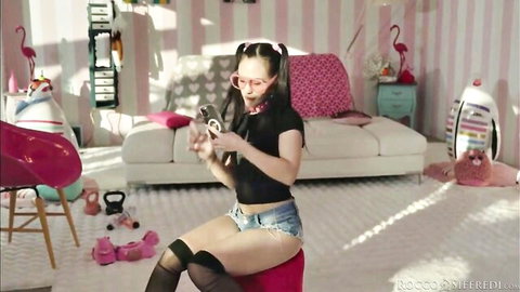 Kitana Lure teases in shorts and stockings, playful pigtails