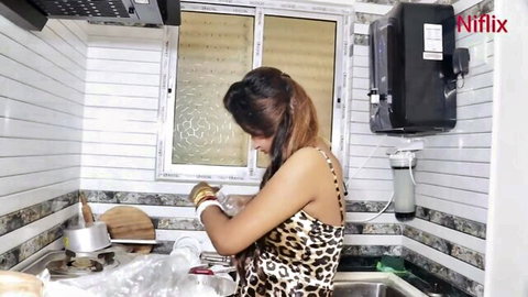 Sexy Indian babe with big tits in tight leopard print top washing dishes in kitchen sink