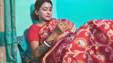 Seductive Indian wife in red saree, teasing with traditional attire