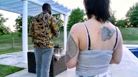 Tattooed brunette mom in striped top with BBC stud outdoors by pool