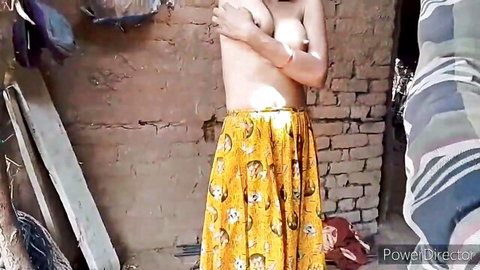 Topless Indian babe shyly covers her perky tits with crossed arms in yellow floral skirt