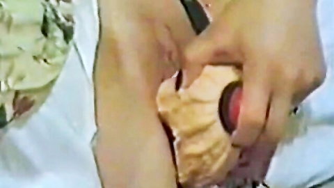 Close-up of shaved pussy spread wide open by fingers exposing pink wet labia.