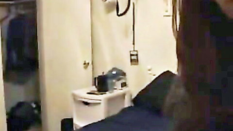 Blurry amateur view of long-haired girl sitting on bed facing closet in bedroom