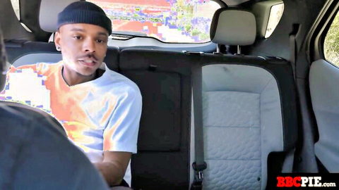 Black stud in beanie and colorful shirt sits smiling in car backseat from BBCPIE