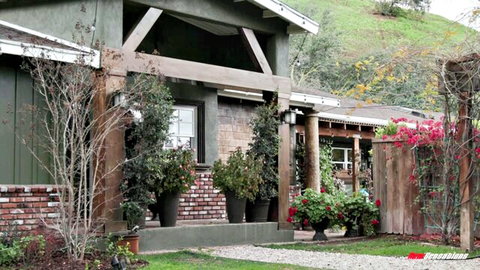 Tiffany Watson outside lush green home in casual outdoor setting