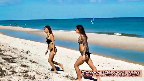 Felicity and tattooed brunette in bikinis tease on sunny beach before 3some