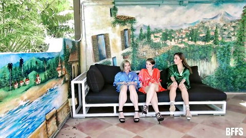 Harlow West, Dani Blu & Dakota Burns in colorful spa robes, legs spread on couch