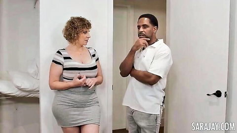 Sara Jay curvy blonde with massive tits and big ass in skirt with black stud