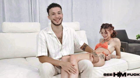Shrooms Q in orange bikini with tattooed Apollo Banks in intimate couch pose