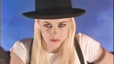 Blonde bombshell in black top hat and suspenders from retro A Clockwork Orgy
