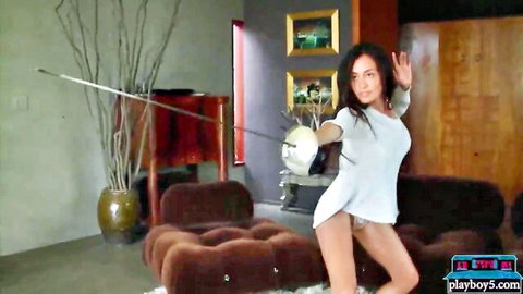 Tanned curvy babe in sheer white top exposing big tits and pink panties in fencing pose showing ass