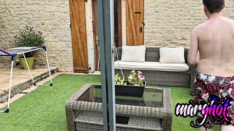 Shirtless man in floral swim trunks outdoors near laundry, naughty stepmom tease